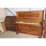 An oak cased upright piano by Foster