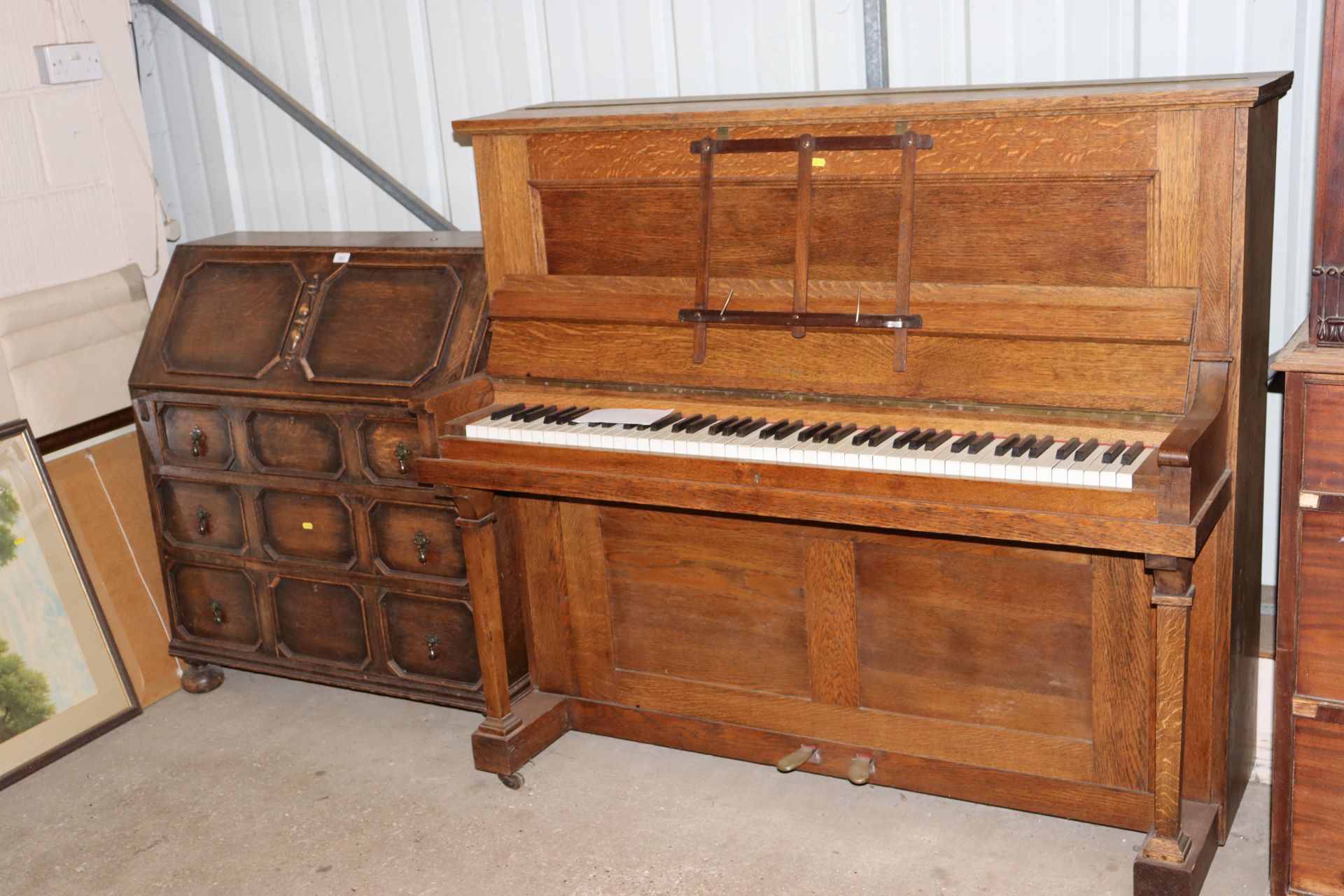 An oak cased upright piano by Foster