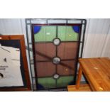 A pair of coloured stained glass window panels