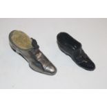 A metal pin cushion in the form of an shoe and a p