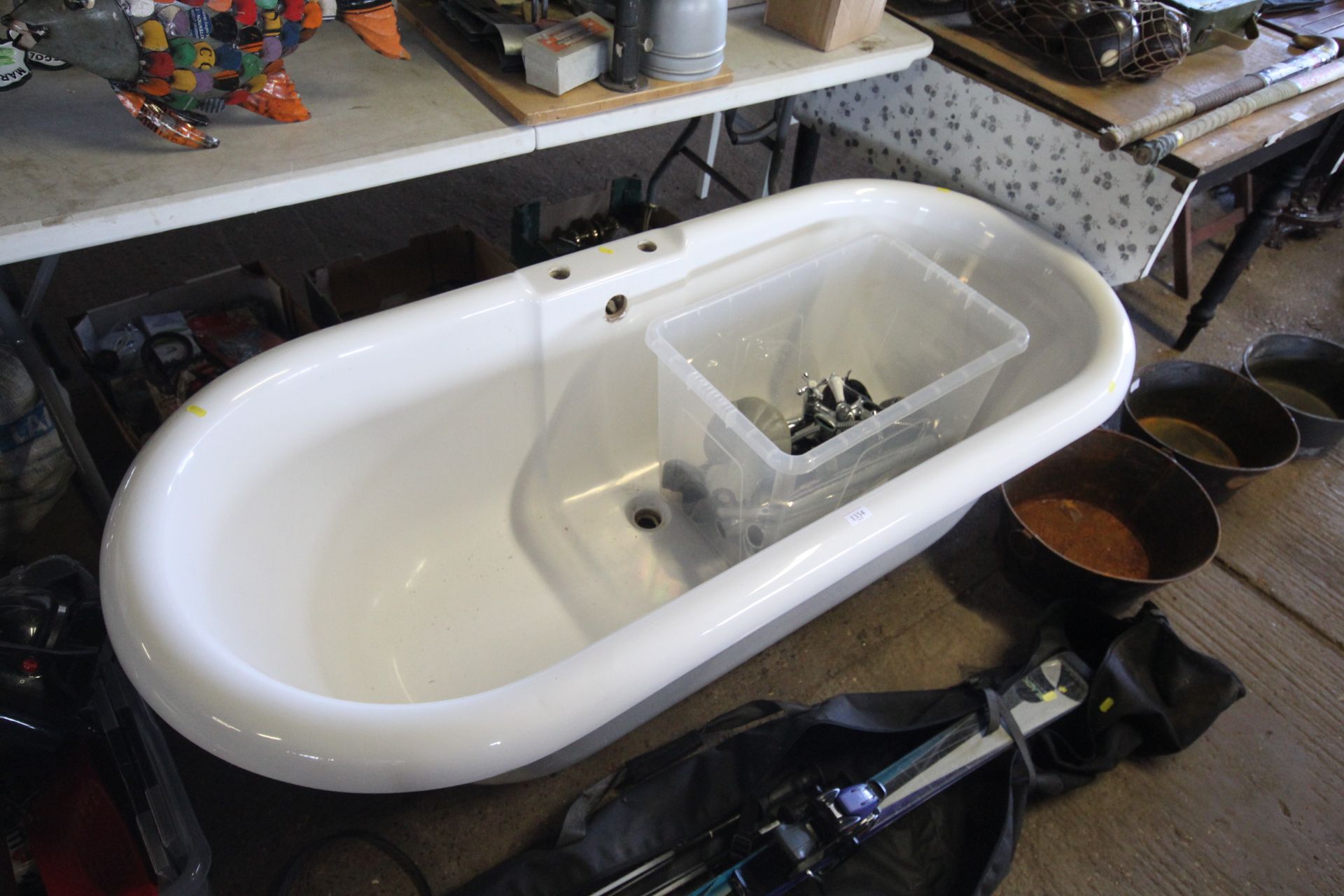 A roll top bath raised on ornate feet (removed) to