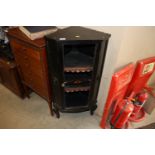 An ebonised corner cupboard