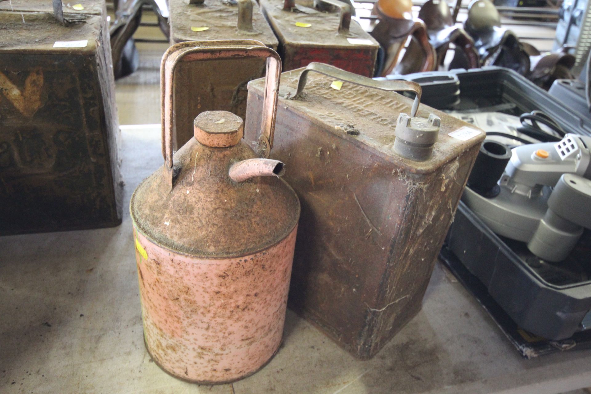 A metal 2 gallon fuel can and a smaller paraffin c