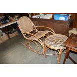 A wicker and cane rocking chair and table