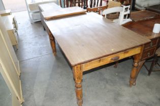 A wood effect top pine kitchen table