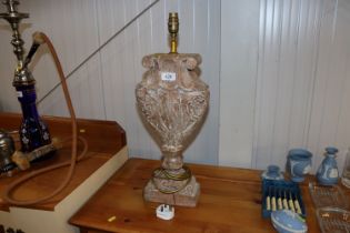 A carved wooden table lamp