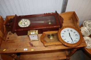 A mantel clock and two wall clocks