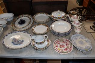 A collection of various pattern dinnerware