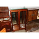 A mahogany display cabinet with glass shelves