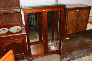 A mahogany display cabinet with glass shelves