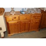 A modern pine sideboard fitted three drawers