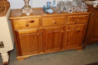 A modern pine sideboard fitted three drawers