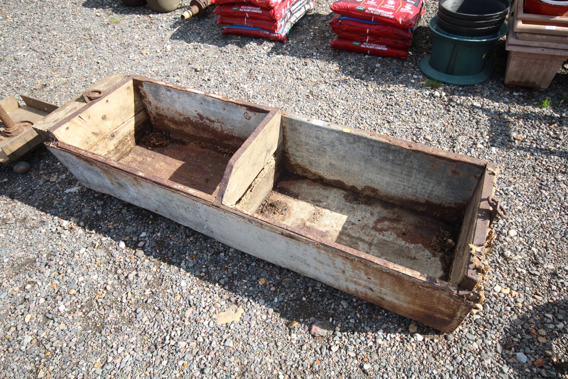A vintage wooden two section feed trough