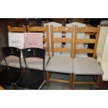 A set of four modern ladder back dining chairs