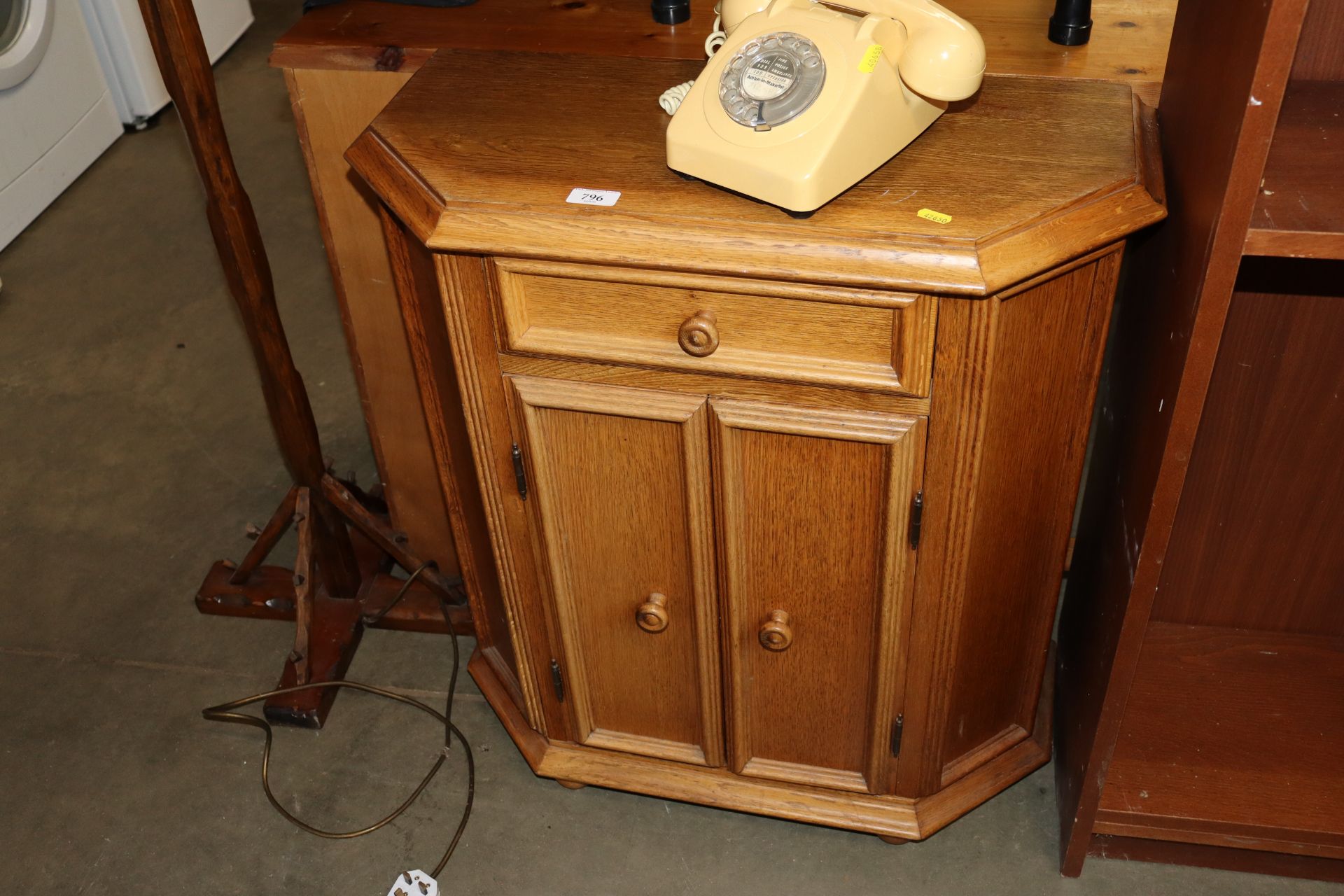 A light oak hall cupboard fitted single drawer