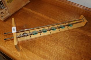 A table top wooden and metal gravitational game