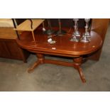 A reproduction oval extending coffee table
