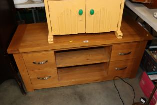 A modern light oak TV stand