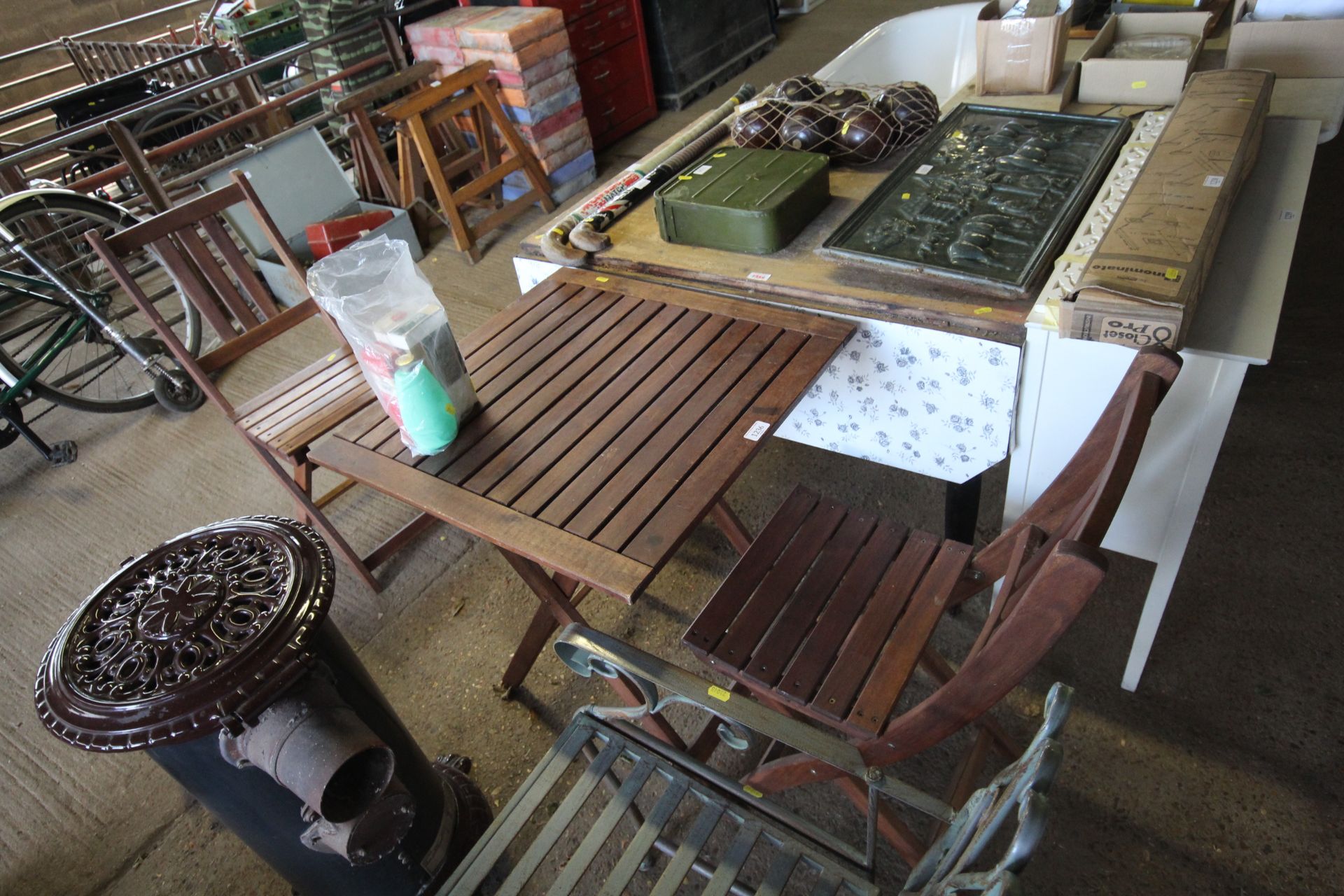 A wooden folding garden table with a pair of match