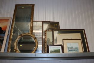 Two wall mirrors; a collection of framed cigarette