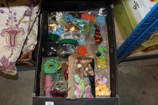 A box of craft items including beads, wires, charm
