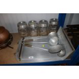 A set of four aluminium kitchen utensils and hangi