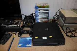 A Sony Playstation 4 with four remote controls and