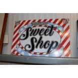 A metal sign "Traditional Sweet Shop"