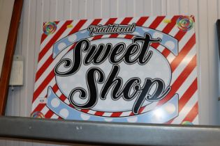 A metal sign "Traditional Sweet Shop"