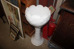 A white glazed jardinière on stand