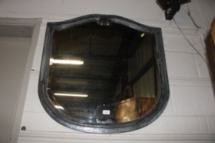 A shaped bevelled edged wall mirror