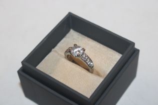 A costume ring set with large white stone and smal