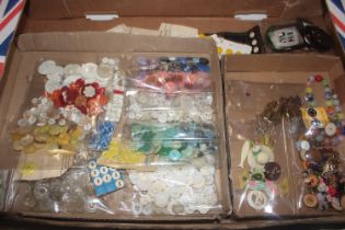 A box of various vintage buttons, brooches etc.