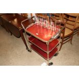 A cocktail trolley with removable top tray togethe