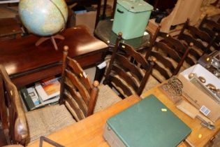 A set of six rush seated ladder back dining chairs