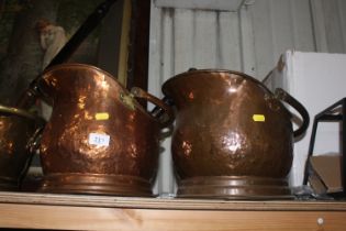 A pair of copper coal helmets with one shovel