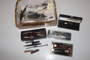 A box containing various fountain pens, mainly in