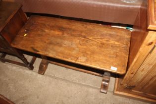 An oak side table raised on stretcher base