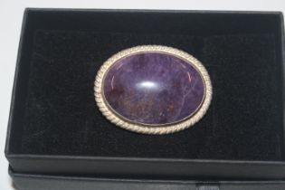 A Sterling silver and amethyst coloured brooch app