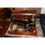 A Singer hand sewing machine in fitted case