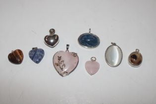 Eight white metal silver mounted pendants including