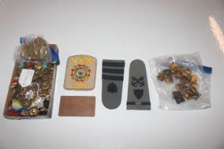 A box containing various military cloth badges, br