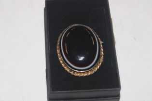 A silver gilt Victorian bulls eye agate brooch, ap