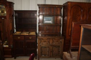 An oak dresser raised on cupboard base, fitted sin