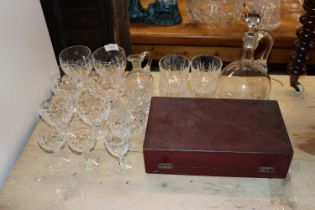 A quantity of cut drinking glasses; claret jug etc