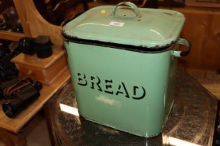 A green enamel bread bin