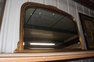 A gilt framed bevel edged overmantel mirror