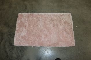 An approx. 3'4" x 2" pink rug