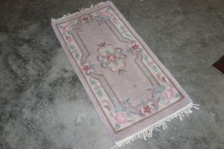 An approx. 4' x 2' floral patterned rug