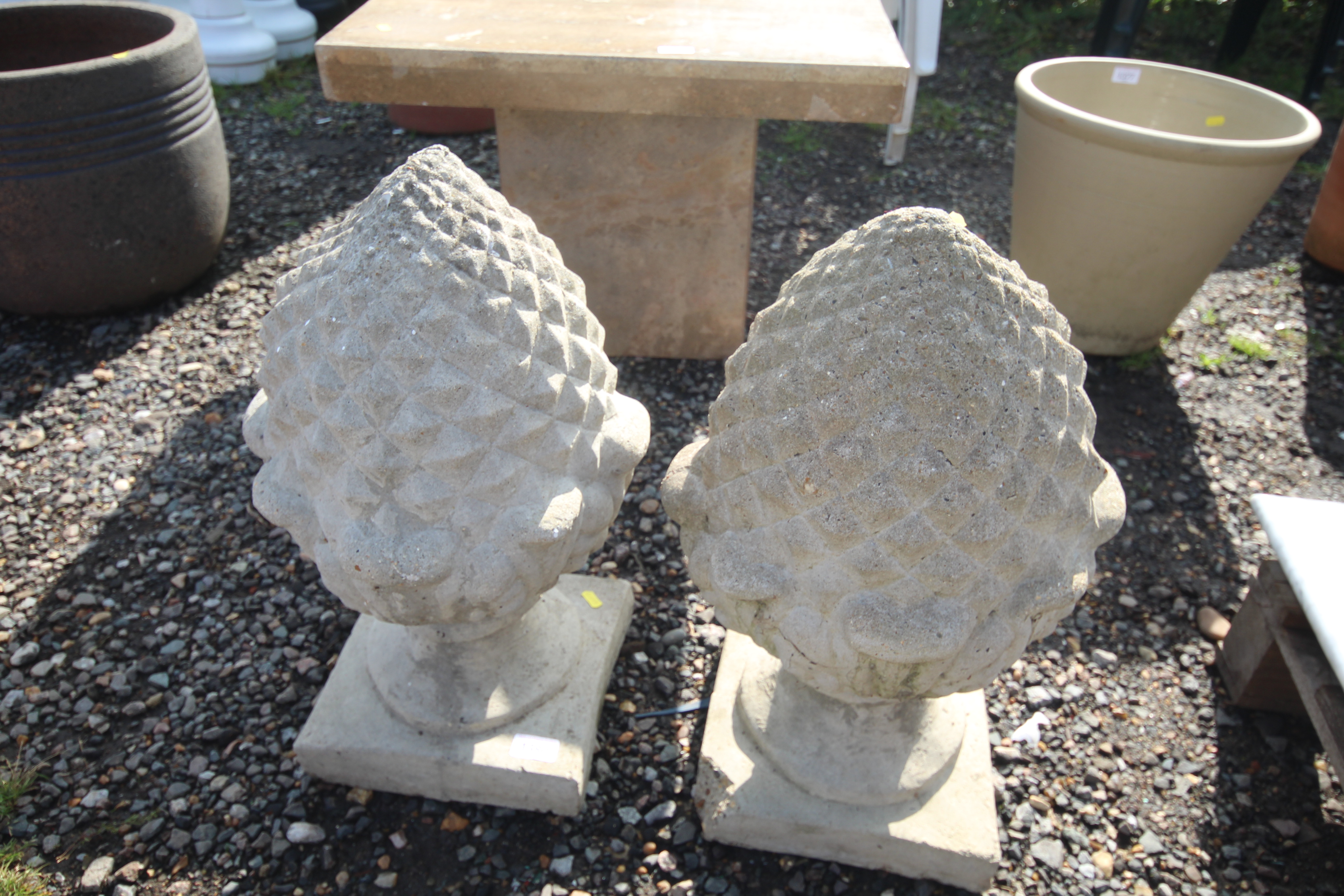 A pair of concrete pineapple style finials, approx